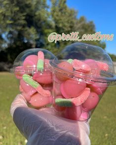 someone is holding up some pink and green candy in their hand with the words opeli customs above them