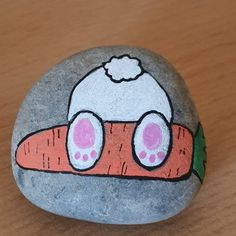 a painted rock with a carrot on it