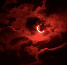 the solar eclipse is seen through dark clouds