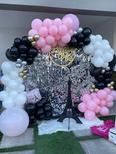 balloon arch with eiffel tower in the background for a paris themed birthday party