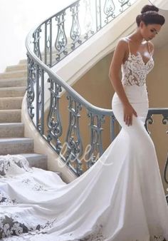 a woman in a wedding dress standing on some stairs