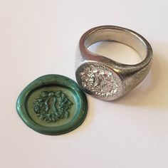 This signet ring is cast in lead-free pewter. The ring size when cast is 5.25, 7.25, 9.25. The sealing image is a Christmas wreath.       This is part of a series of signet rings I am making cast from lead-free pewter. Each master ring is hand sculpted to give a unique, rustic style, multi-dimensional relief image when used as a stamp to seal, with sealing wax. Stamp Rings, Rings Signet, Stamped Rings, Signet Rings, Sealing Wax, Wax Seal, Wax Seals, Signet Ring, Rustic Style