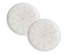 two white plates with spider web designs on them