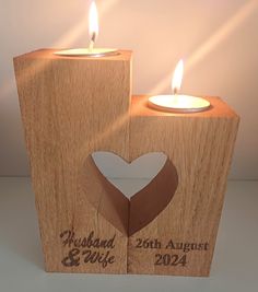 two wooden blocks with candles in the shape of hearts