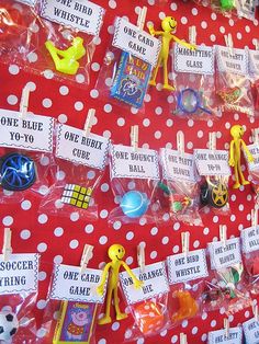 there are many toys on the table for sale in this shopfront window, including plastic figures and cards