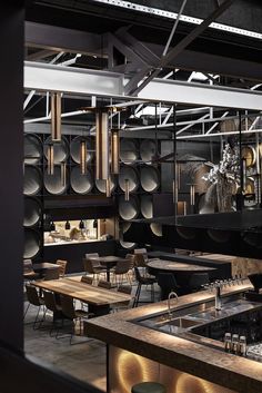 the interior of a restaurant with wooden tables and chairs