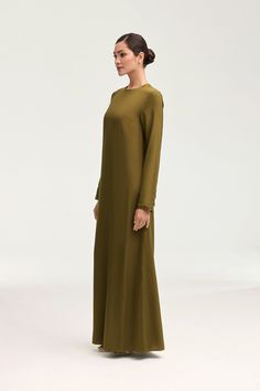 Indulge in luxury with the Estee Viscose Maxi Dress in Olive Night. Crafted with breezy viscose material, this dress boasts a modest fit and straight sleeves perfect for the summer. Dress it up or down and enjoy the ultimate comfort and effortless style no matter the occasion. Elevate your wardrobe with this exquisite piece. Model is 5'7" and is wearing size XS/58". White Dress Formal, Dresses Flowy, Nikkah Dress, Modest Fits, Engagement Dresses, Kids Outerwear, Dress Satin, Basic Dress, Ribbed Dresses