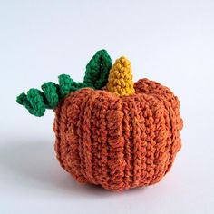 a crocheted pumpkin sitting on top of a white table