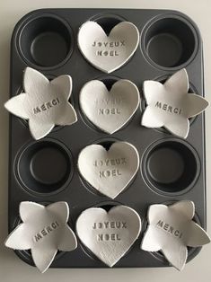 six heart shaped cupcakes with names on them in a muffin tin, ready to be eaten