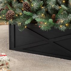 "Find this Glitzhome® Black Wood Tree Collar at Michaels. com. Handcrafted from sturdy and durable solid wood featuring an X-shape design, this tree collar brings you a modern farmhouse Christmas. Handcrafted from sturdy and durable solid wood featuring an X-shape design, this tree collar brings you a modern farmhouse Christmas. Two panels have been pre-assembled with hinges and the other two panels features right-angle bolt for easy installation, ensuring convenience and neatness. Details: Blac Industrial Farmhouse Christmas, Wooden Tree Collar, Collar Tree, Tree Collar Christmas, Christmas Tree Box, Tree Box, Tree Collar, Corrugated Metal, Holiday Store