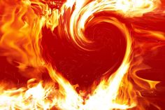 a heart shaped object on fire with flames around it