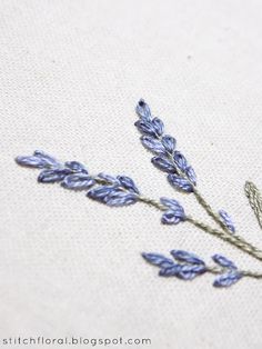 the embroidery is stitched with lavender flowers