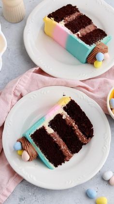 two slices of chocolate cake on plates with candy candies and eggs in the background