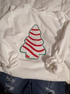 "This is a beautiful \"Lil Debbie Christmas Tree Cake\" chenille patch on a unisex sweatshirt of your choice.  Looks best on Black, white, red or green sweatshirts!  To request a specific color sweatshirt, please message me, I will do my best to accommodate your color preference, depending on color availability at no additional cost" White Fleece T-shirt For Winter, Casual Holiday Hoodie With Crew Neck, White Cotton Christmas Sweatshirt, White Winter Sweatshirt As A Gift, White Winter Sweatshirt For Gift, White Embroidered Sweatshirt As Winter Gift, Holiday Embroidered Casual Sweatshirt, White Sweatshirt For Winter Gift, White Winter Sweatshirt Gift