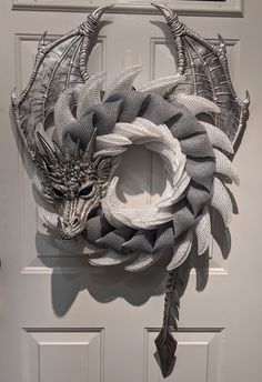 a dragon head made out of mesh hanging on a door