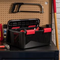 a toolbox filled with tools on top of a workbench