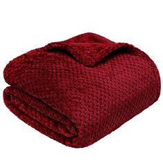 a red blanket is folded on top of a white background and it's textured