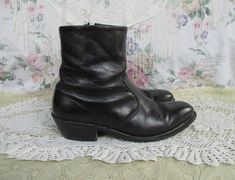 Nice black leather Chelsea style ankle boots made by HH in the USA. These have a Western style embroidery on the pointed toes, and some unique embroidery around the ankles as well. The soles look like nice quality and are stitched. There is a zipper on the inside ankle for ease in getting on. Lined in a brown material. There is some general wear, most notably some scuffing and some wear and a scratch in the toe area. But overall these are lovely and ready to wear! The soles have a squishy paddin Vintage Fitted Boots For Festivals, Vintage Fitted Festival Boots, Black Western Boots With Leather Sole, Black Western Boots With Reinforced Heel, Vintage Black Leather Chelsea Boots, Punk Bohemian, Black Western Boots Vintage, Luxury Black Western Mid-calf Boots, Beatle Boots