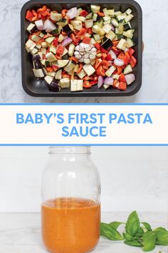 baby's first pasta sauce in a glass jar next to a tray with chopped vegetables