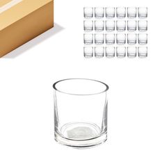 several glasses are sitting next to each other on a white surface and some cardboard boxes