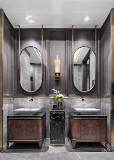 a bathroom with two sinks and mirrors on the wall