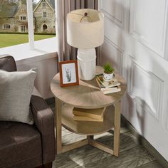 a living room with a chair, table and lamp next to a large open window