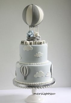 a three tiered cake with an air balloon on top