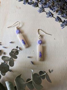 These hook earrings feature a beige granite rectangular design adorned with lavender accents, creating an elegant and versatile accessory for any occasion. Handmade Trendy Lavender Jewelry, Trendy Handmade Lavender Jewelry, Trendy Lavender Earrings For Gift, Beige Rectangular Jewelry Gift, Trendy Beige Earrings For Gift, Handmade Minimalist Purple Earrings, Handmade Rectangular Earrings For Everyday, Handmade Rectangular Everyday Earrings, Handmade Everyday Rectangular Earrings