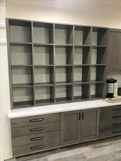 an empty room with several shelves and drawers