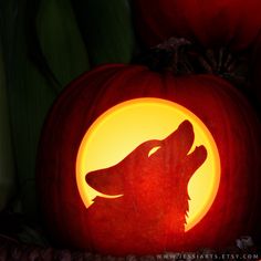 a carved pumpkin with a wolf on it