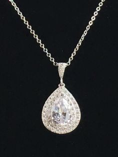 Beautiful! clear cubic zirconia bridal tear drop pendant and necklace in rhodium plated brass setting. Necklace pendant features a large teardrop with pear cut cubic zirconia center surrounded by two rows of tiny zirconia crystals which dangles from a cubic zirconia detailed bail. Length of the rhodium plated chain is 18 inches and comes with 2 inches extender and lobster clasp. For matching earrings click: https://www.etsy.com/listing/495791548/teardrop-crystal-earrings-bridal-cubic?ref=listing Classic Teardrop Bridal Necklace With Diamond Accents, Classic Brilliant Cut Drop Necklace For Wedding, Formal Cubic Zirconia Teardrop Pendant Bridal Necklace, Formal Cubic Zirconia Teardrop Bridal Necklace, Formal Teardrop Necklace With Sparkling Stones, Formal Teardrop Drop Necklace With Sparkling Stones, Formal Teardrop Drop Necklace With Diamond Cut, Diamond White Teardrop Pendant Drop Necklace For Formal Events, Diamond White Teardrop Pendant Drop Necklace For Formal Occasions