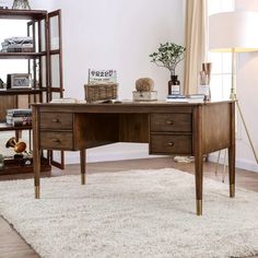 a wooden desk sitting on top of a white rug