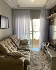 a living room filled with furniture and a flat screen tv