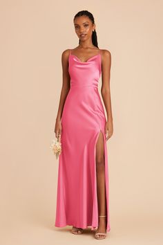 a woman wearing a pink dress with a slit