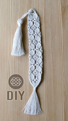 a white crochet tassel on top of a wooden table