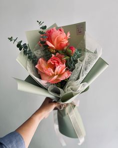 a person holding a bouquet of flowers in their hand