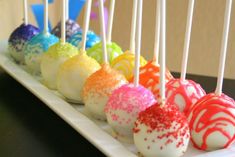 a row of cake pops on a white plate