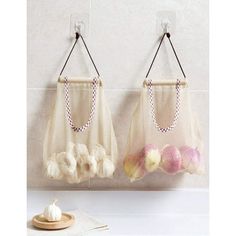 there are two bags hanging on the wall and one is filled with cotton balls in it