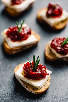 small crackers topped with cranberry sauce and whipped cream