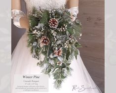 a bridal bouquet with pine cones, berries and greenery is displayed on a mannequin