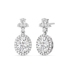 Elevate your style to new heights with our Large Oval with Halo Drop Earrings. These magnificent earrings are not just jewelry; they are a masterpiece that defines luxury and sophistication. With a combination of large oval diamonds, a stunning halo, and a diamond cluster top featuring a blend of pear and round-shaped diamonds, these earrings are a captivating statement of your unique taste and unmatched elegance. Luxury Oval Bridal Earrings For Formal Occasions, Luxury Oval Bridal Earrings With Prong Setting, Elegant Diamond White Halo Diamond Earrings, Elegant Diamond Halo Earrings, Timeless Formal Diamond Earrings With Halo Detail, Timeless Formal Diamond Earrings With Halo, Formal Timeless Halo Diamond Earrings, Exquisite Oval Diamond Earrings With Accents, Luxury Oval White Gold Bridal Earrings