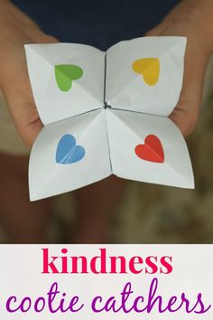 someone holding an origami heart in their hands with the text, kindnesscote catchers