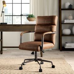 a brown office chair sitting on top of a rug