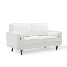 a white couch sitting on top of a wooden floor