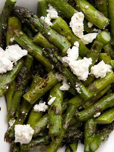 asparagus with feta cheese in a white bowl