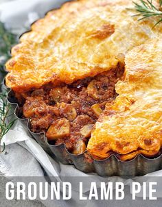 a close up of a pie in a pan with the words ground lamb pie on it