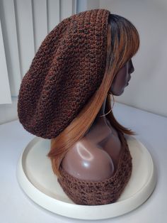 a mannequin head wearing a brown knitted hat