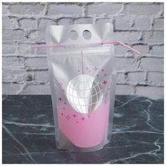 a pink and white plastic cup with a straw in it