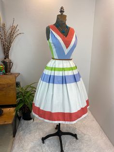 1950s dress / 50s dress / 1960 dress / 60s dress / fit and flare This 1950s / 1960s dress is perfect for a warm day. She is a cotton fit and flare with a new side zipper. She is a creamy white with a striped pattern in salmon, blue, and green. She has the typical nipped waist and full pleated skirt. She looks beautiful with a petty coat under or without! Measurements provided are flat and have been doubled. Bust 34" Waist 24.5 / 25" Hips free Length 39" ❤️ Condition: Excellent vintage condition. Petty Coat, 1960 Dress, 1960s Dress, 1960's Dress, 60s Dress, 50s Dresses, 1950s Dress, Fashion Pieces, 50s Fashion