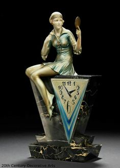 a clock with a woman sitting on top of it and holding a spoon in her hand